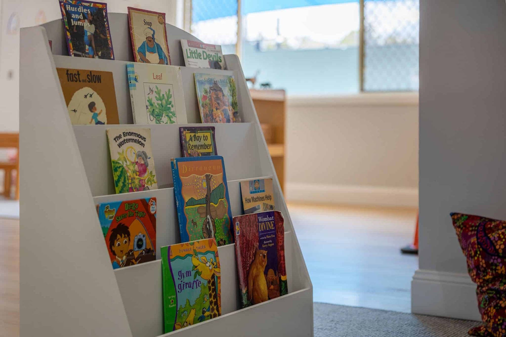 A front-facing bookcase filled with picture books